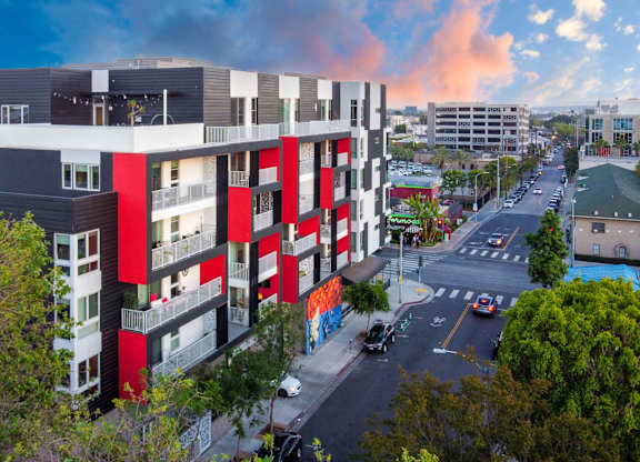 Contemporary building with bold red and white facade at Domain WeHo Apartments, Santa Monica, CA