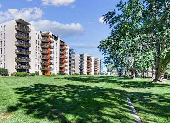 A grassy area in front of apartment buildings. at The Lex At Lowry, Denver