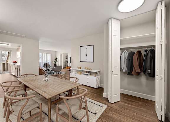 A room with a table and chairs and a wardrobe. at The Lex At Lowry, Denver, CO, 80224