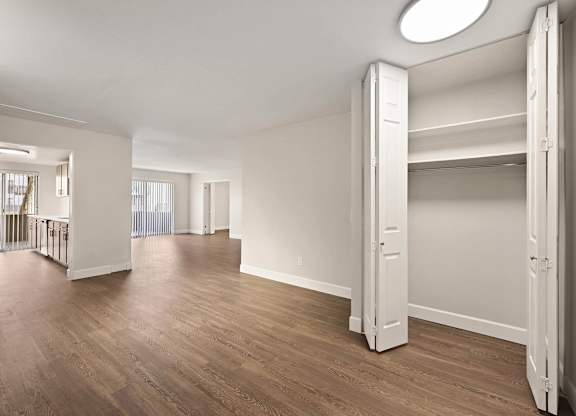 A large, empty room with wooden floors and white walls. at The Lex At Lowry, Denver, Colorado