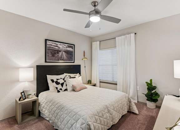 A bedroom with a bed, a ceiling fan, and a painting on the wall.at Onyx183, Texas, 78729