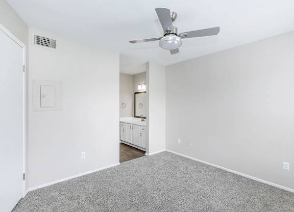 Spacious bedroom with carpet and en suite bathroom at Park at LeBlanc Apartments, Fort Worth, TX