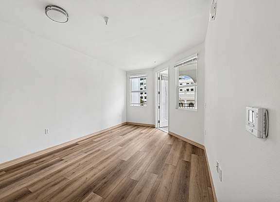Spacious room with wooden floor at Parkview Living Apartments, Los Angeles, CA