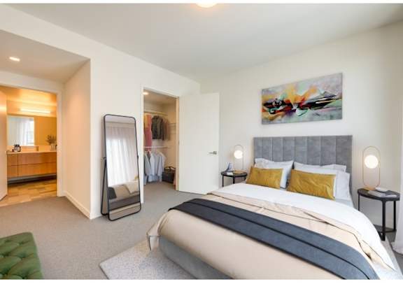 A bedroom with a large bed and a painting on the wall.at Prizma, Los Angeles, CA 90038  