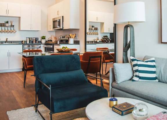 Living room with kitchen view at Sora Apartments, Inglewood, CA
