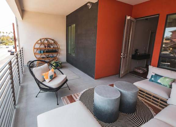 Patio with chairs and couch at Sora Apartments, Inglewood, CA