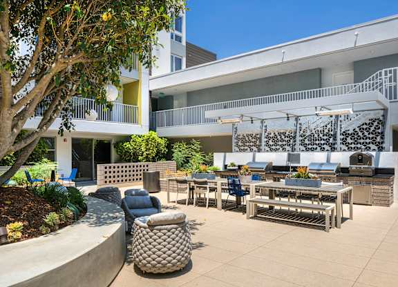 A patio area with a table and chairs.