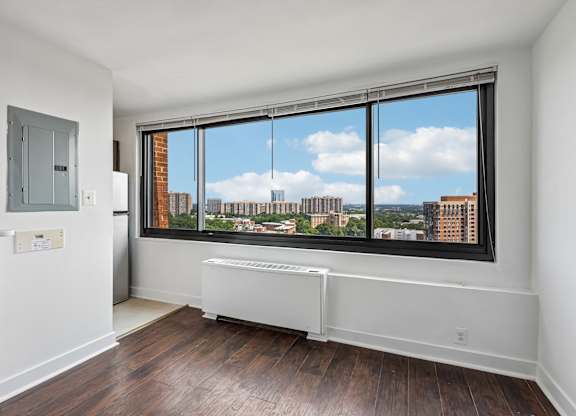 A room with a window overlooking a cityscape.