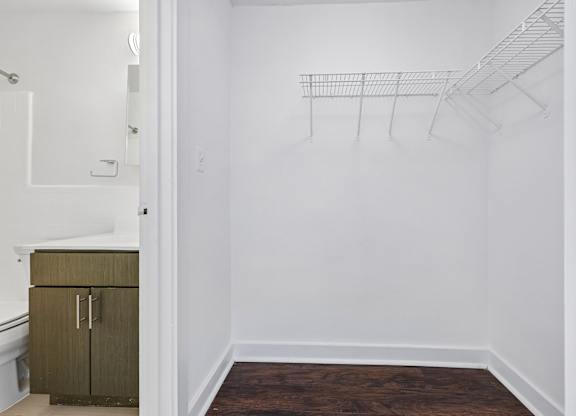 A white wall with a wire rack on it.