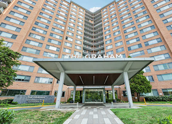 The Graham apartment building has a covered walkway leading to the entrance.