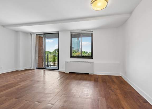 A room with a window and a sliding glass door.