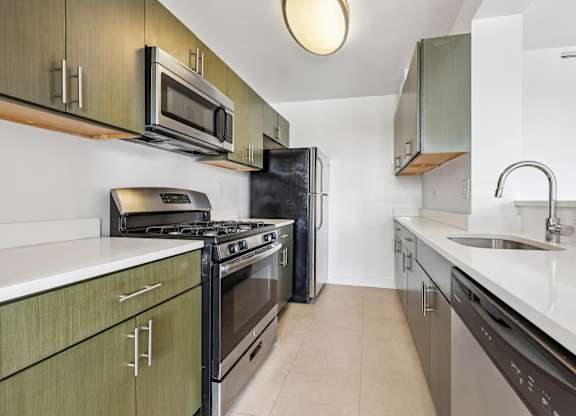 A modern kitchen with a black stove top oven and a black refrigerator.