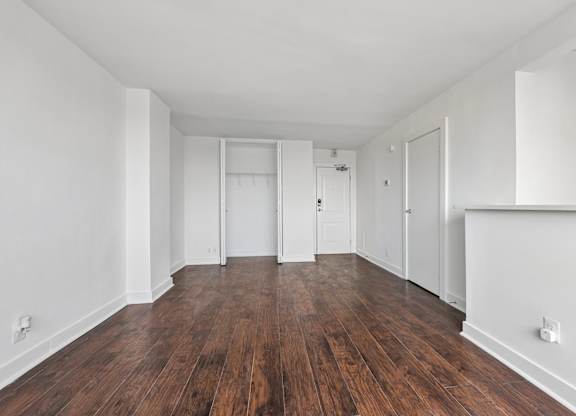 A room with wooden floors and white walls.