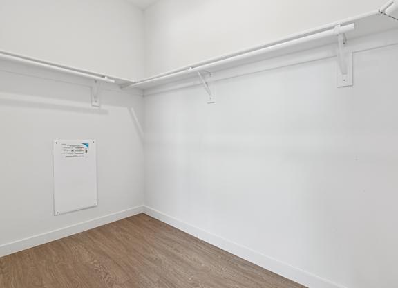 A white wall with a poster and a white pipe.
