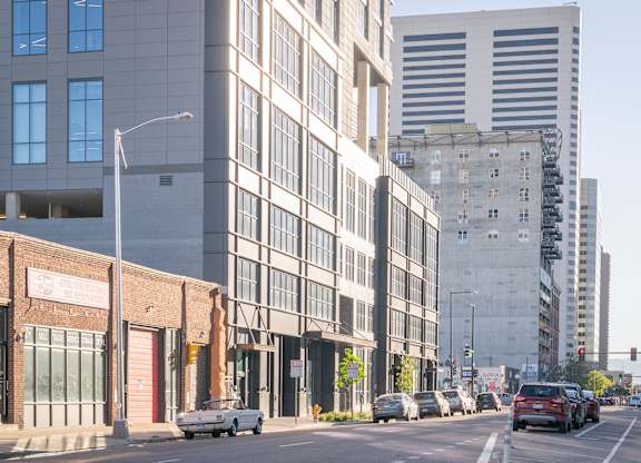 City street with cars and buildings at Velaris Living Apartments, Denver, CO
