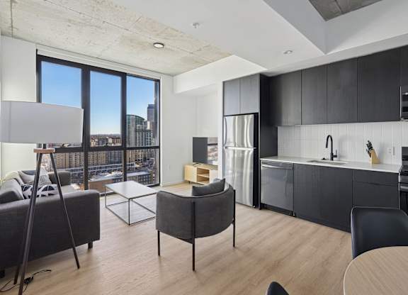 Kitchen with black cabinets at Velaris Living Apartments, Denver, CO