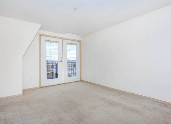 Empty room with a window and a door.
