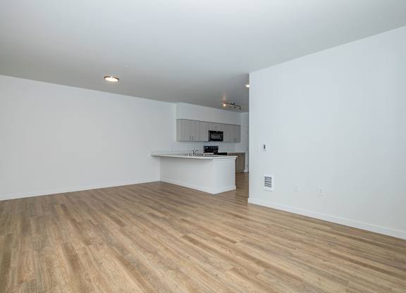 A room with wooden floors and white walls.
