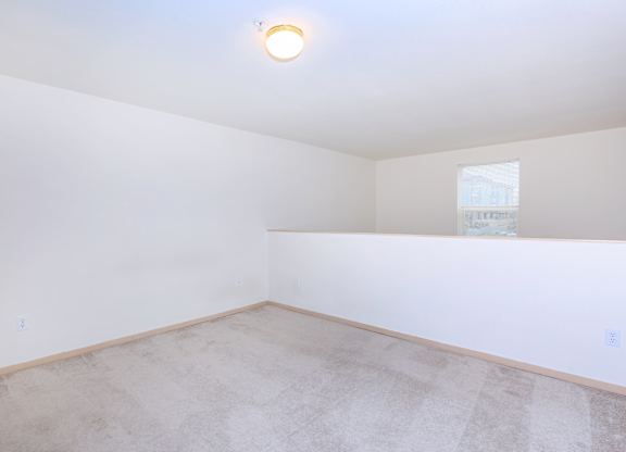 A room with a light on the ceiling and a window on the wall.