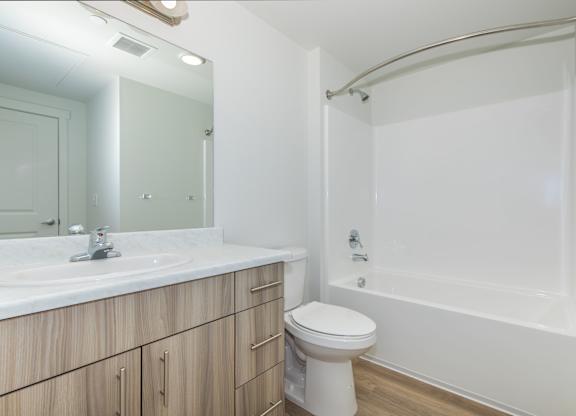 A white toilet sits next to a sink in a bathroom.