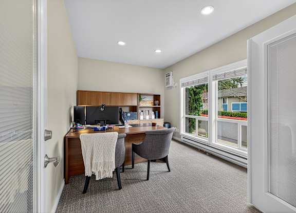 A home office with a desk, chair, and computer.