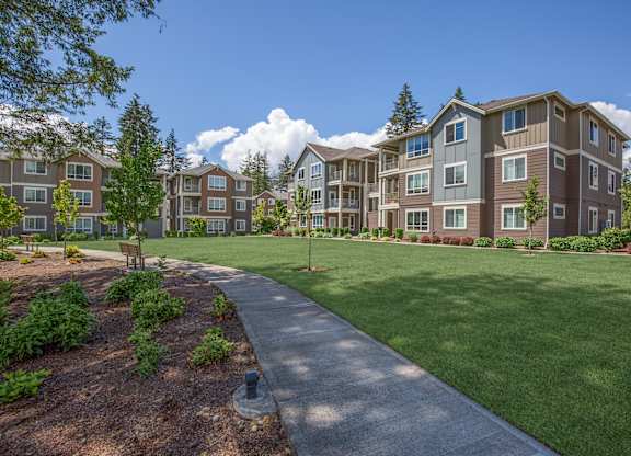 Apartment complex with a walkway in the foreground.