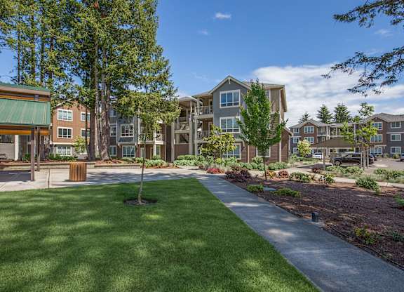 A grassy area in front of apartment buildings.