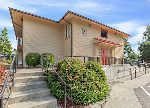 A building with a red door and a sign that says "B" on it.