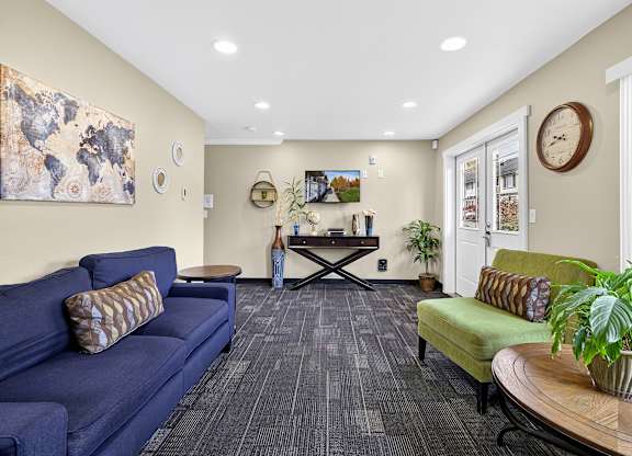 A living room with a blue couch and a wooden coffee table.
