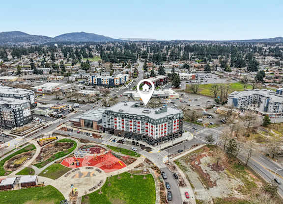A bird's eye view of a city with a large building in the center.
