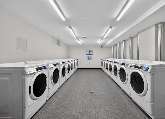 A row of washing machines in a laundromat.