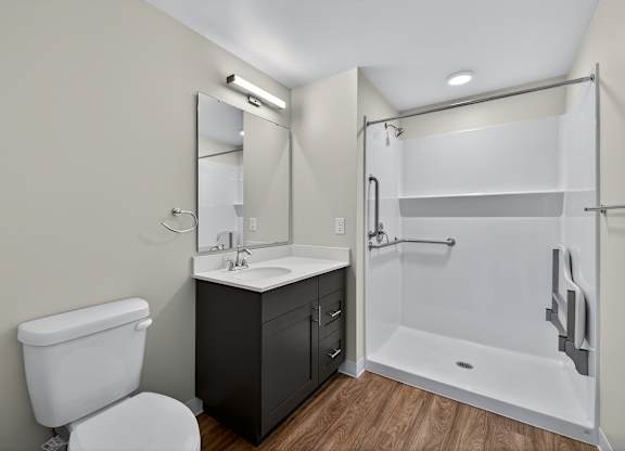 A white toilet sits next to a sink in a small bathroom.