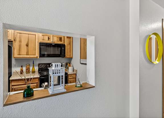 A kitchen with wooden cabinets and a white stove.