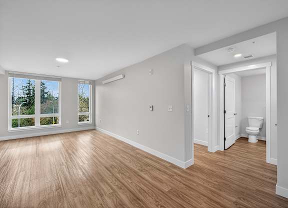 A room with a toilet and a window.