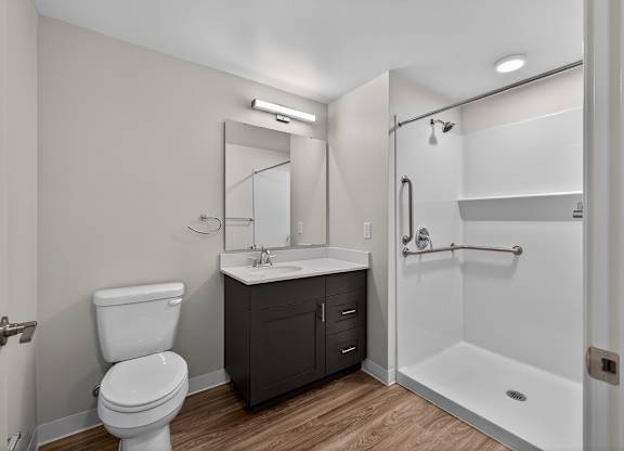 A white toilet sits next to a sink in a bathroom.