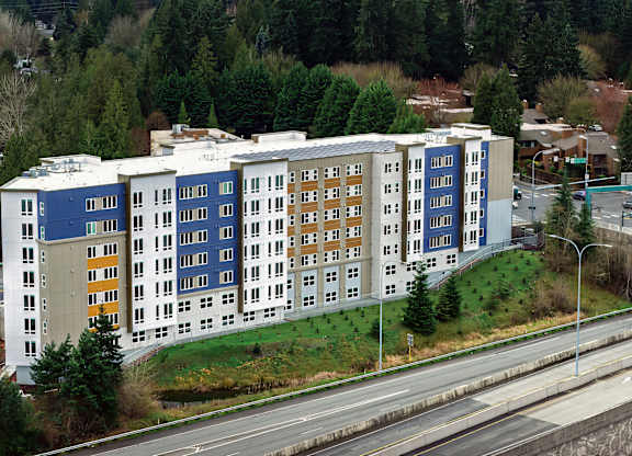 A large multi-story building with a blue and white exterior.