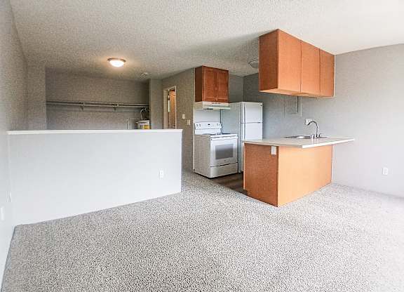 A kitchen with a white fridge and a white oven.