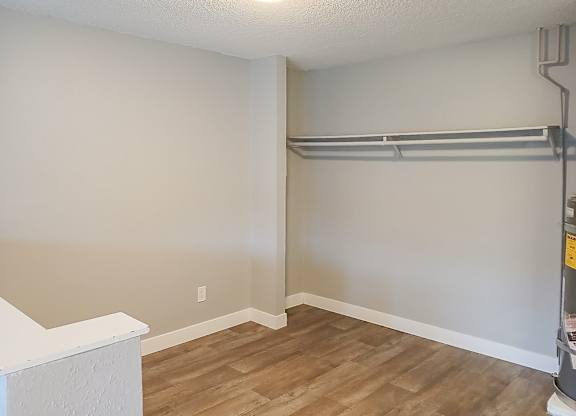 A room with a white ceiling and a wooden floor.