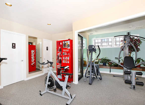 A gym with a Coca Cola vending machine.