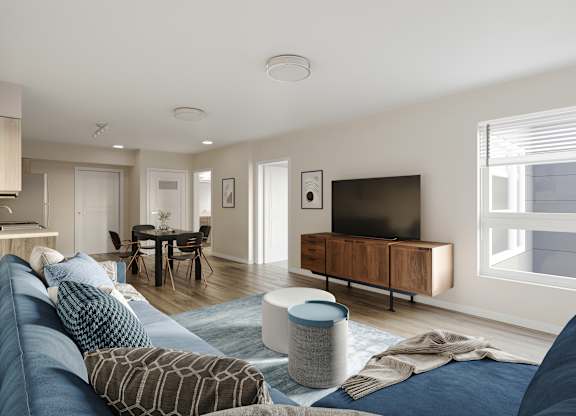 A modern living room with a blue sofa and a television.