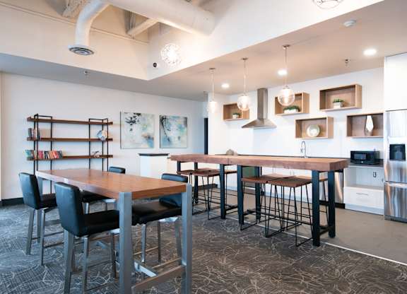 A modern kitchen with a dining table and chairs.