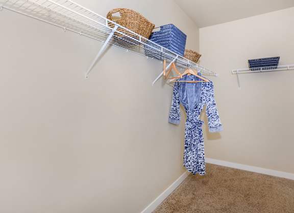 A baby onesie is hanging on a clothesline in a room.