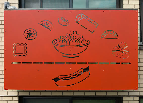 A red sign with black food drawings on it.
