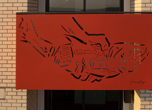 A red banner with a black design and the name "T. Dozy" on it.