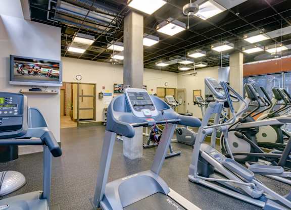 A gym with treadmills and exercise bikes.
