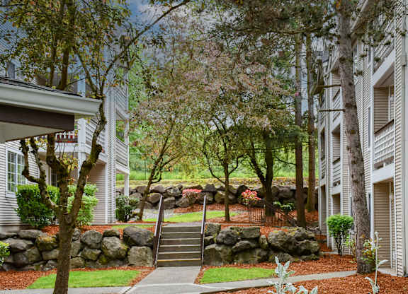 A residential area with a stone wall and a staircase.