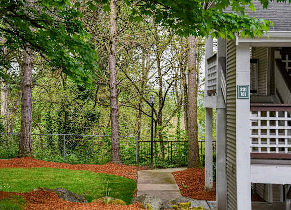 A house numbered 201 sits in front of a tree-lined yard.
