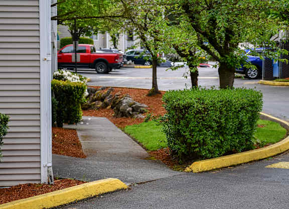 A red truck is parked in a parking lot.