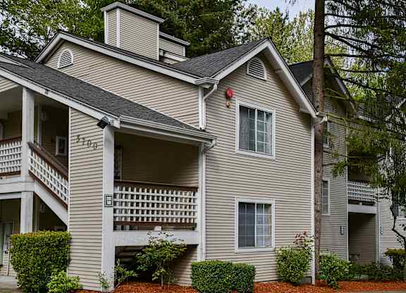 A two-story house with a balcony on the second floor.