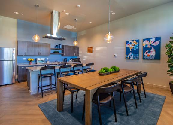 A modern kitchen with a dining table and chairs.